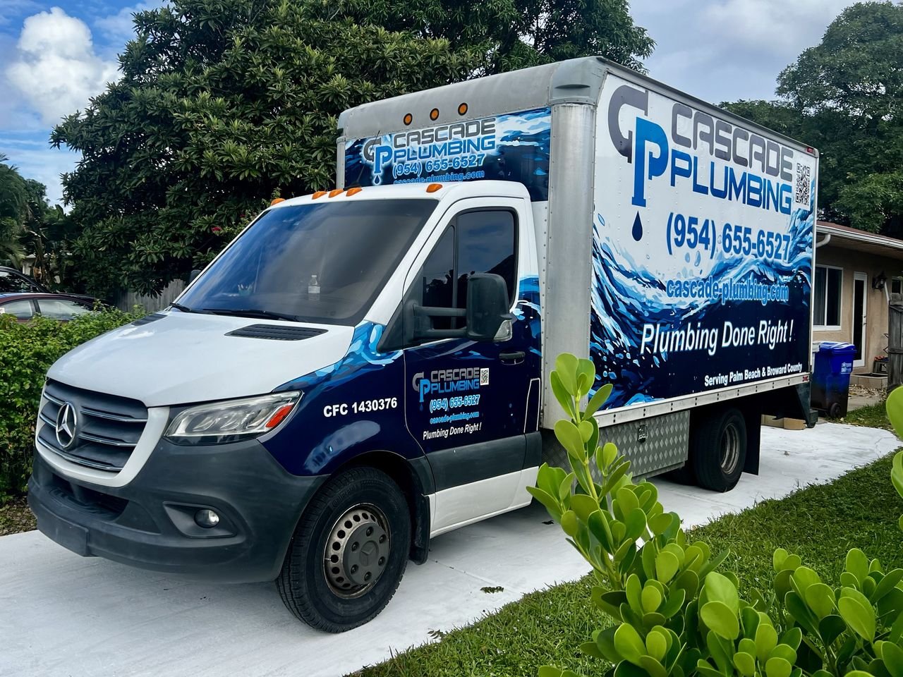 Cascade Plumbing's branded work truck with the company logo and phone number